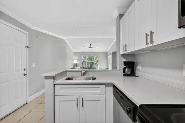 a kitchen with a sink cabinets and window