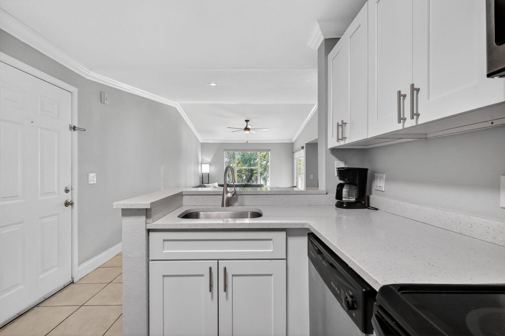 1740 Palm Cove Boulevard, Unit 4307 Delray Beach, FL 33445 - Photo 5 of 31 a kitchen with a sink cabinets and window