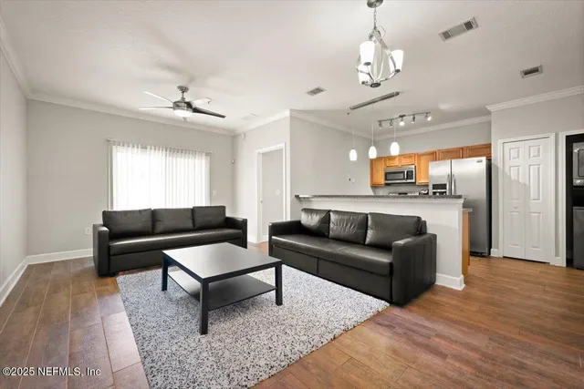a living room with furniture and a chandelier