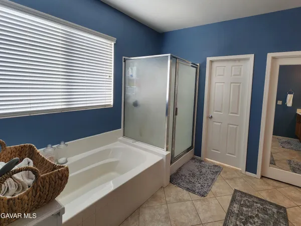 a spacious bedroom with a bed and a couch