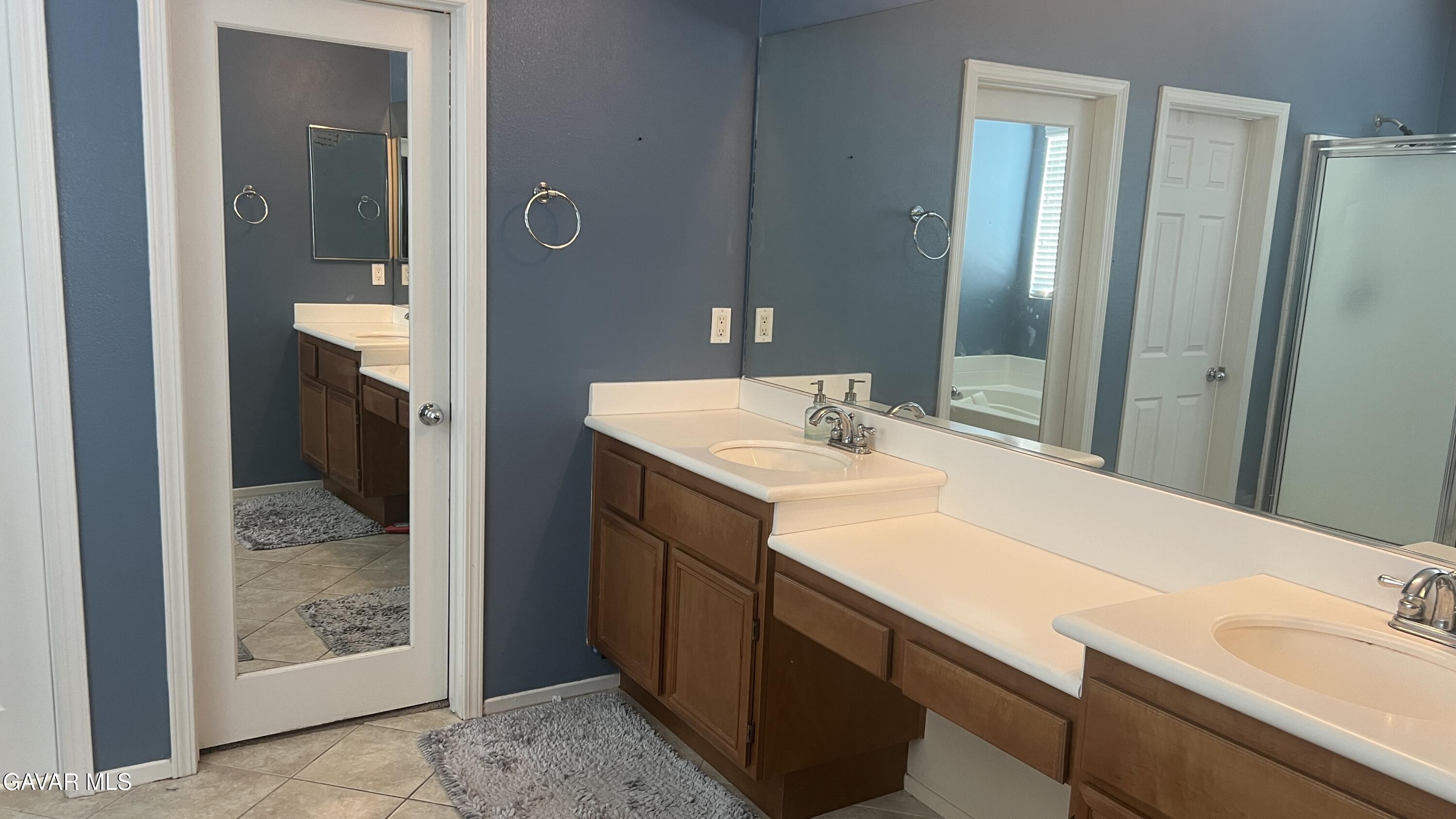 44741 Ruthron Avenue Lancaster, CA 93536 - Photo 12 of 13 a bathroom with a sink and a mirror