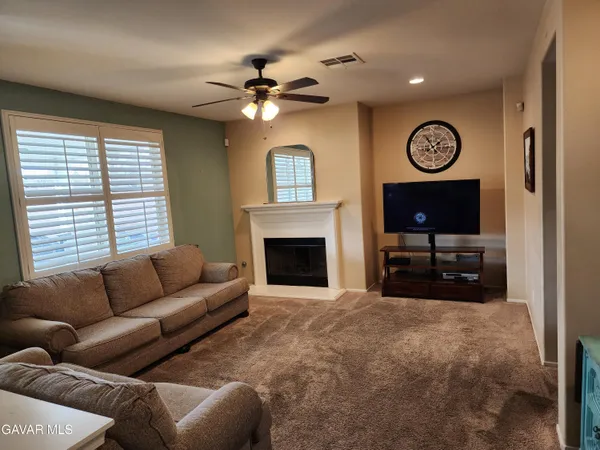 a living room with furniture a clock and a window