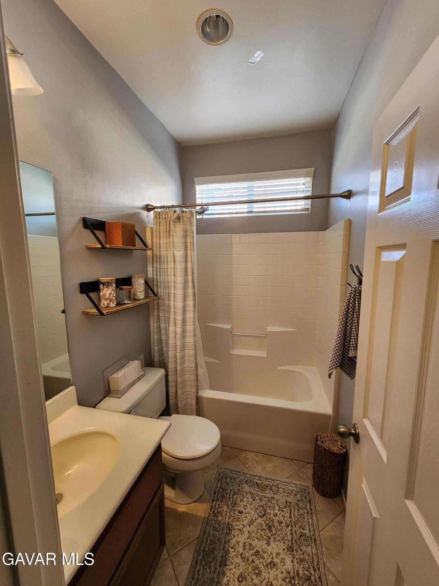 44741 Ruthron Avenue Lancaster, CA 93536 - Photo 6 of 13 a bathroom with a sink and a shower