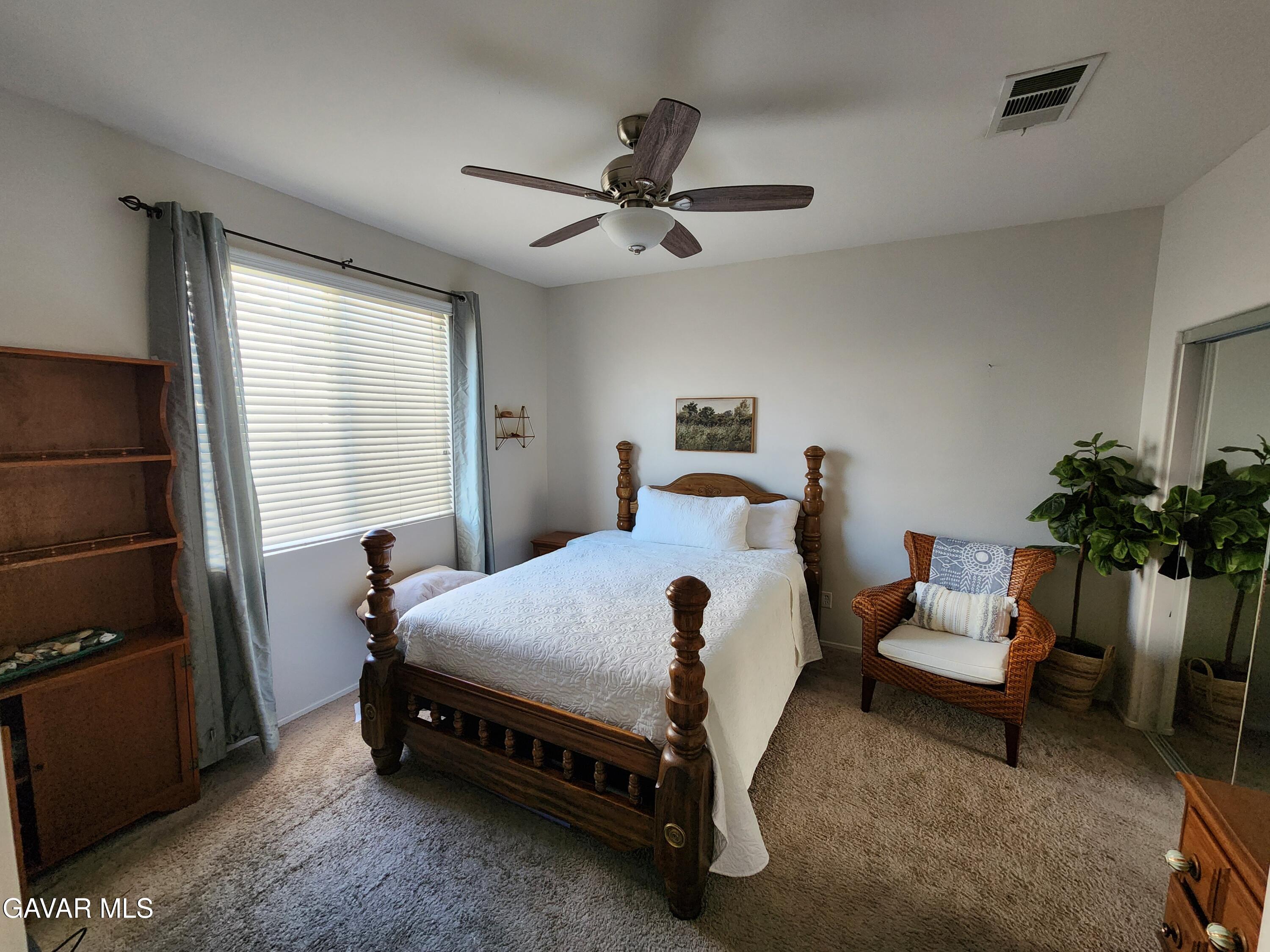 44741 Ruthron Avenue Lancaster, CA 93536 - Photo 7 of 13 a bedroom with a bed and a window