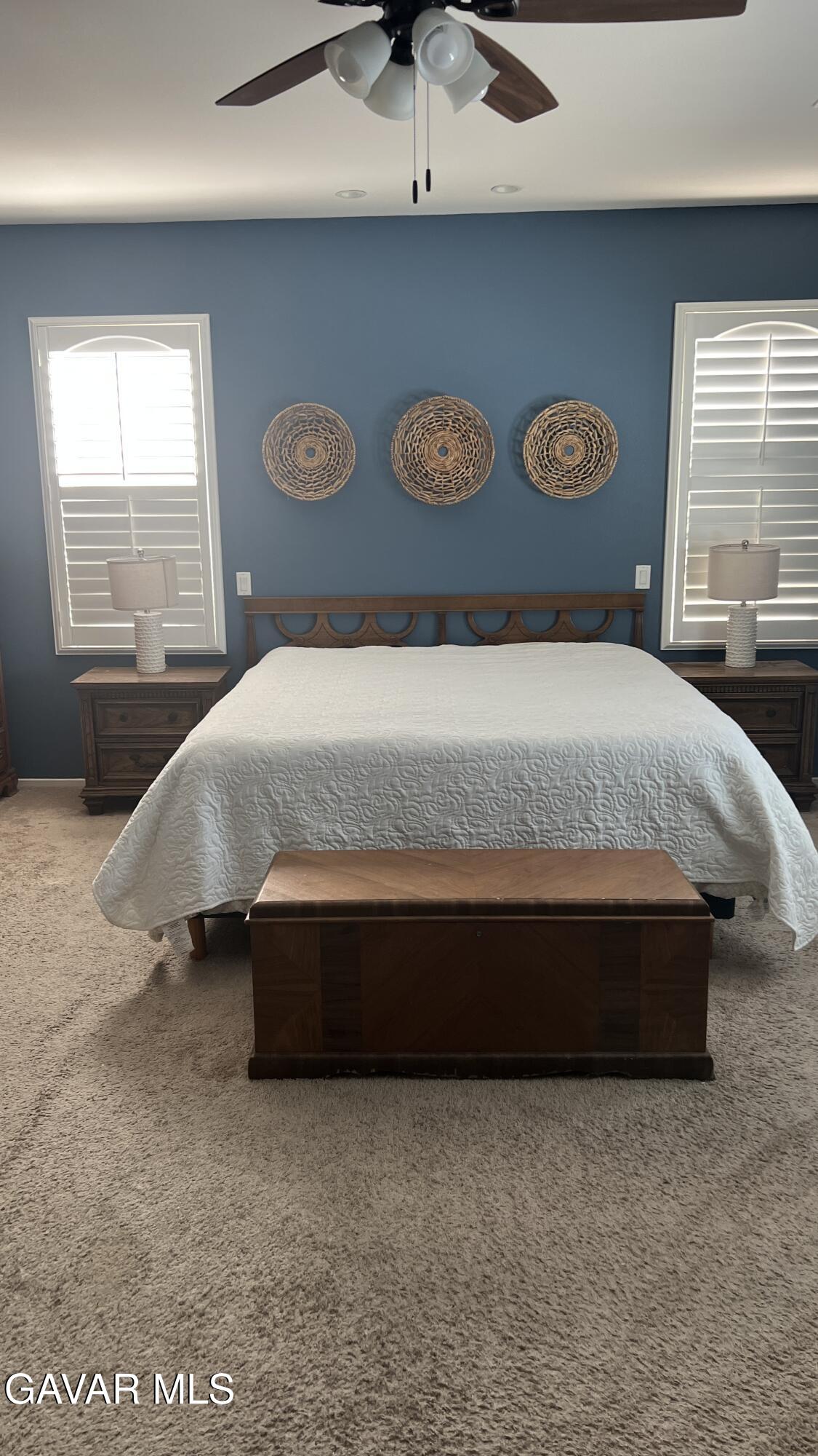 44741 Ruthron Avenue Lancaster, CA 93536 - Photo 9 of 13 a bedroom with a bed and a window