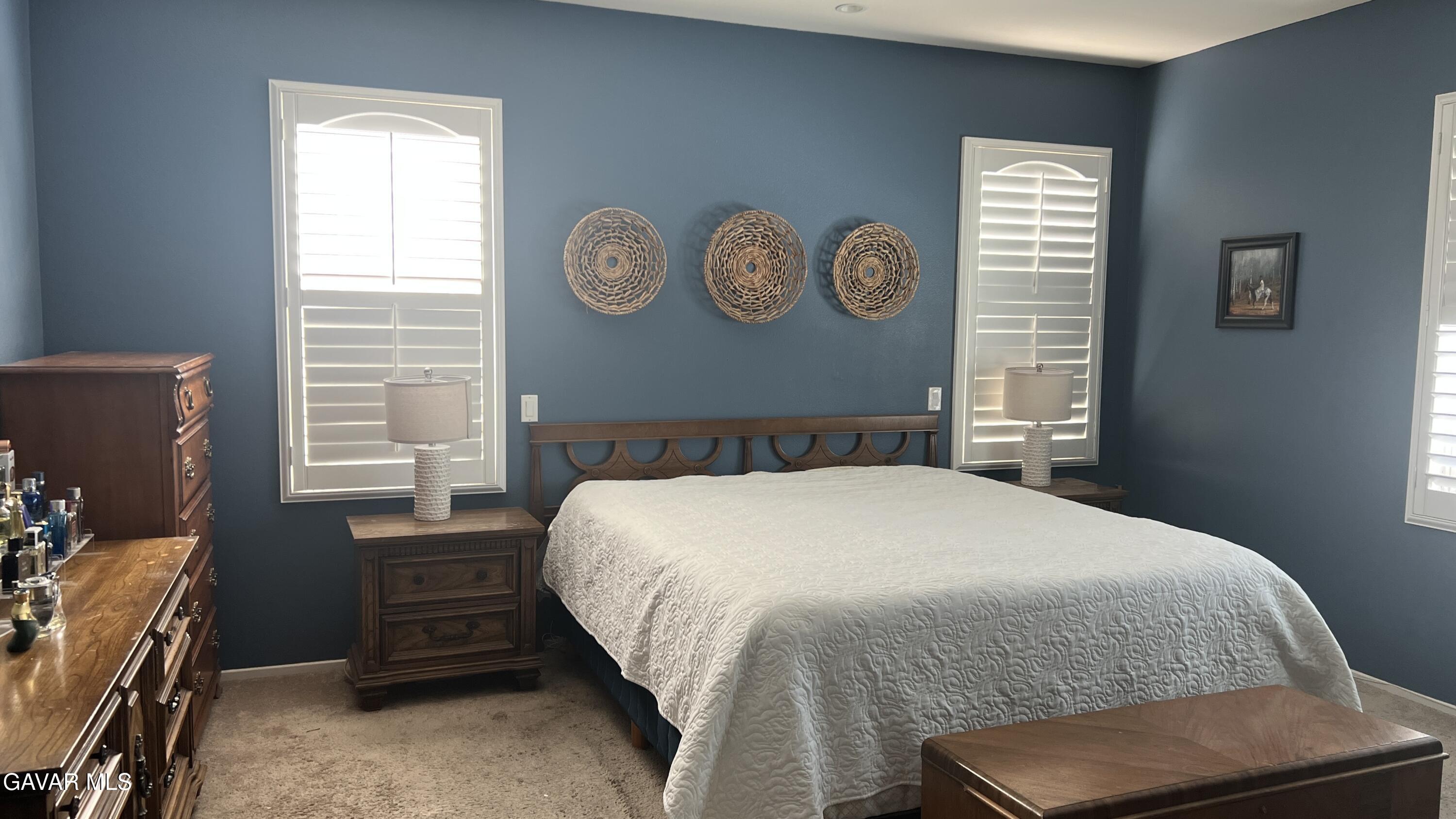 44741 Ruthron Avenue Lancaster, CA 93536 - Photo 9 of 13 a bedroom with a bed and a window