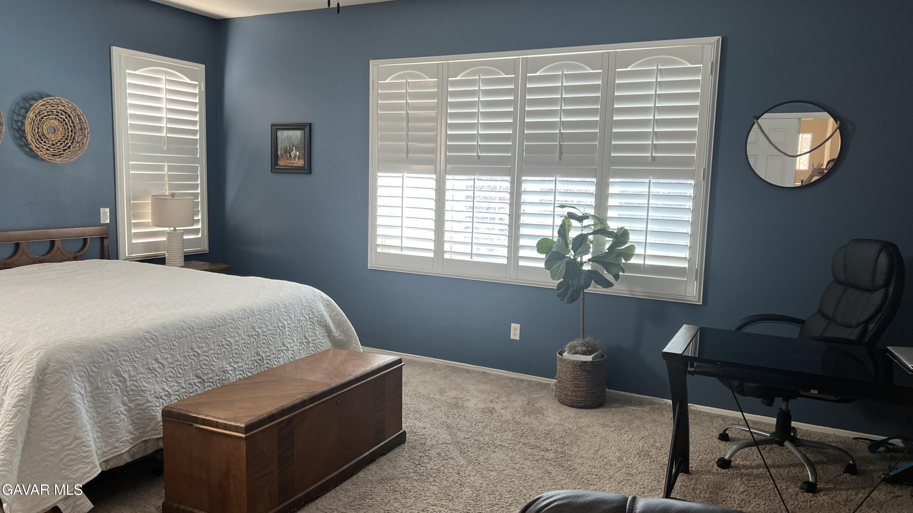 44741 Ruthron Avenue Lancaster, CA 93536 - Photo 10 of 13 a bedroom with a bed and a window
