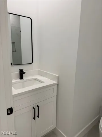 a bathroom with a sink and mirror