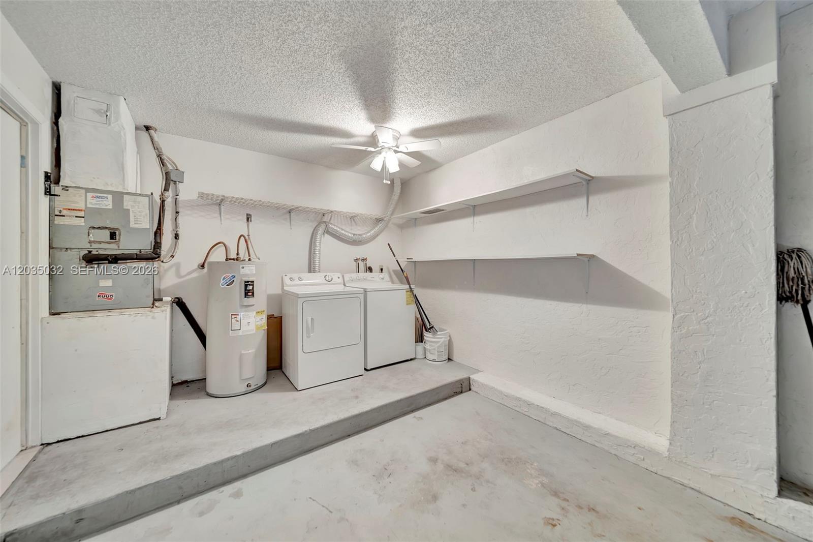 5223 Gate Lake Road, Unit 5223 Tamarac, FL 33319 - Photo 37 of 37 a utility room with cabinets and washer