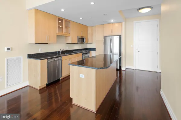 a view of a kitchen with wooden floor