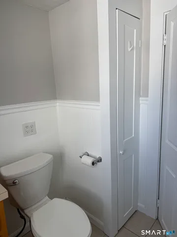 a white toilet sitting next to a bathroom sink