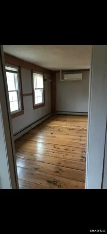 a view of room with window and hardwood floor