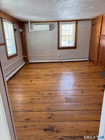 a view of room with window and hardwood floor
