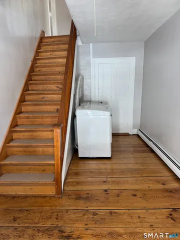 a view of a room with stairs and white walls