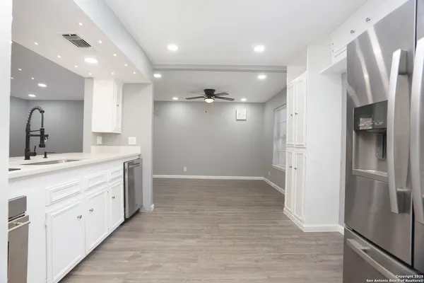 a kitchen with stainless steel appliances a refrigerator and a sink