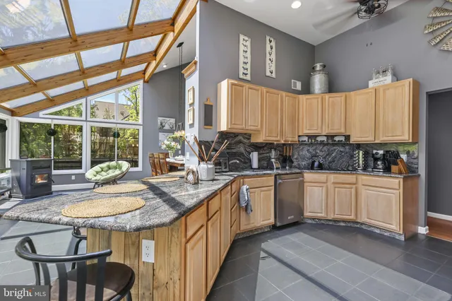 a kitchen with a sink window and cabinets