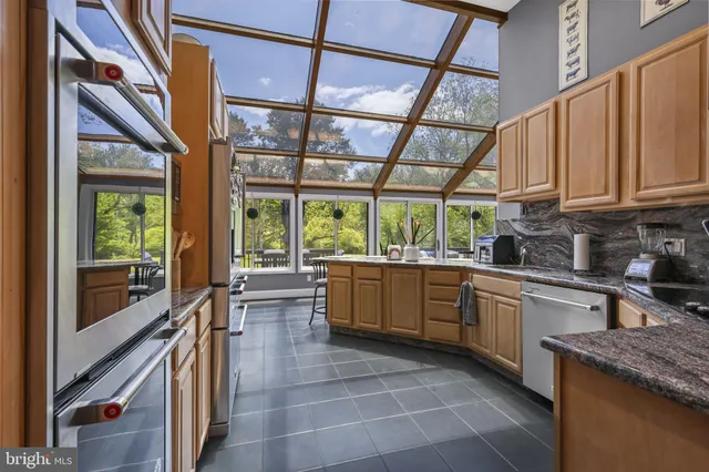 a kitchen with stainless steel appliances granite countertop a refrigerator and cabinets