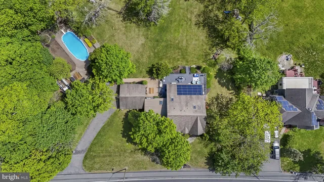 an aerial view of a house with a yard and trees