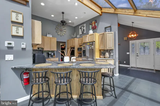 a view of a patio with table and chairs potted plants with wooden floor and fence