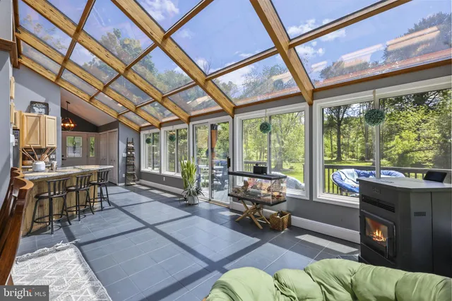 a bedroom with a large bed and a flat tv screen on dresser