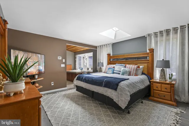 a bedroom with a bed and with furniture