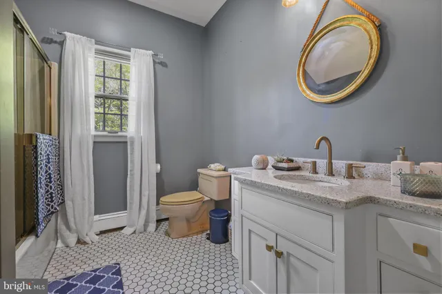 a living room with furniture fireplace and a large window