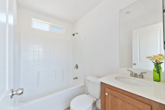 a bathroom with a sink toilet vanity and bathtub