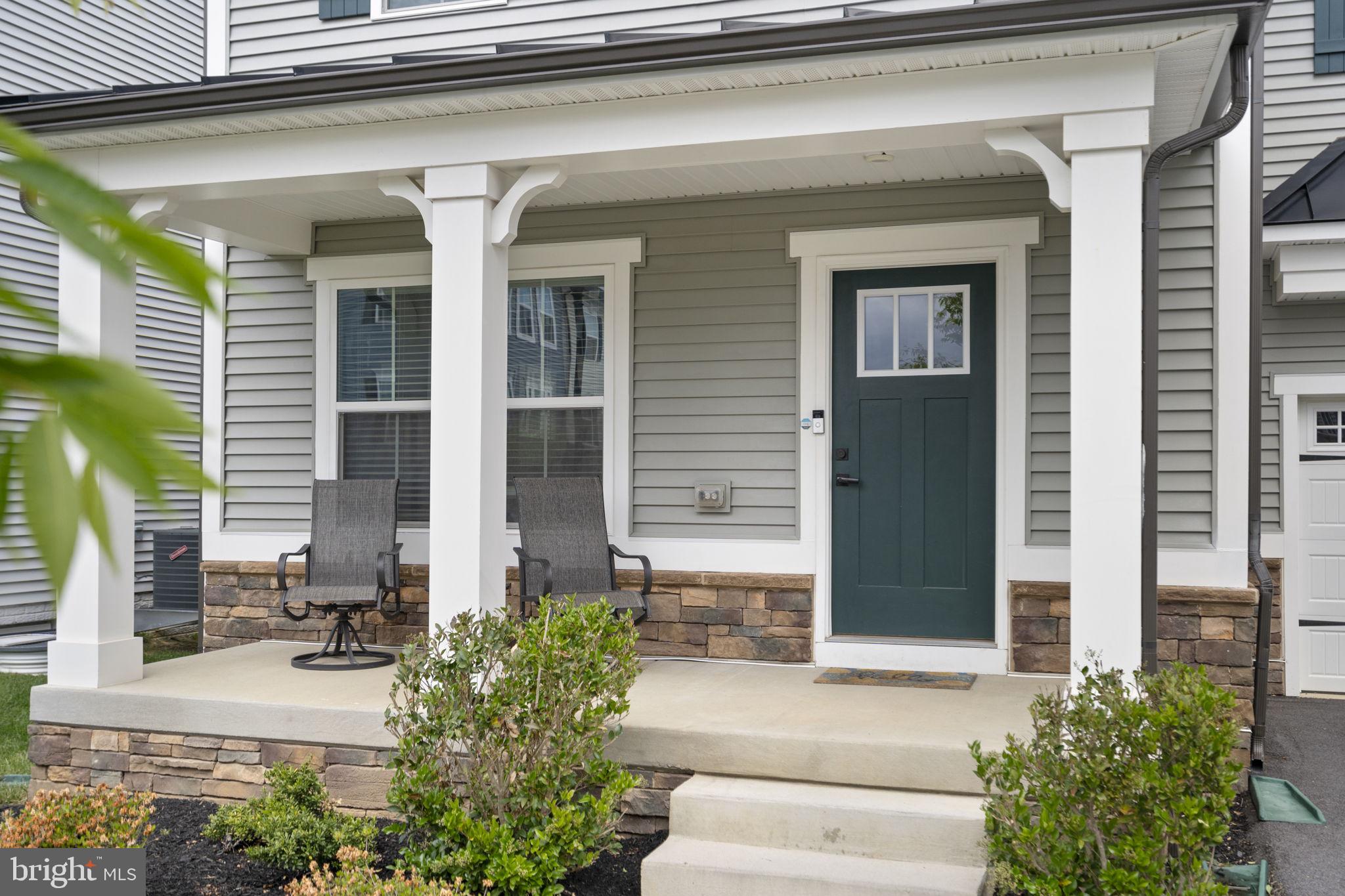 1713 Aurora Way Frederick, MD 21702 - Photo 4 of 57 a front view of a house with potted plants