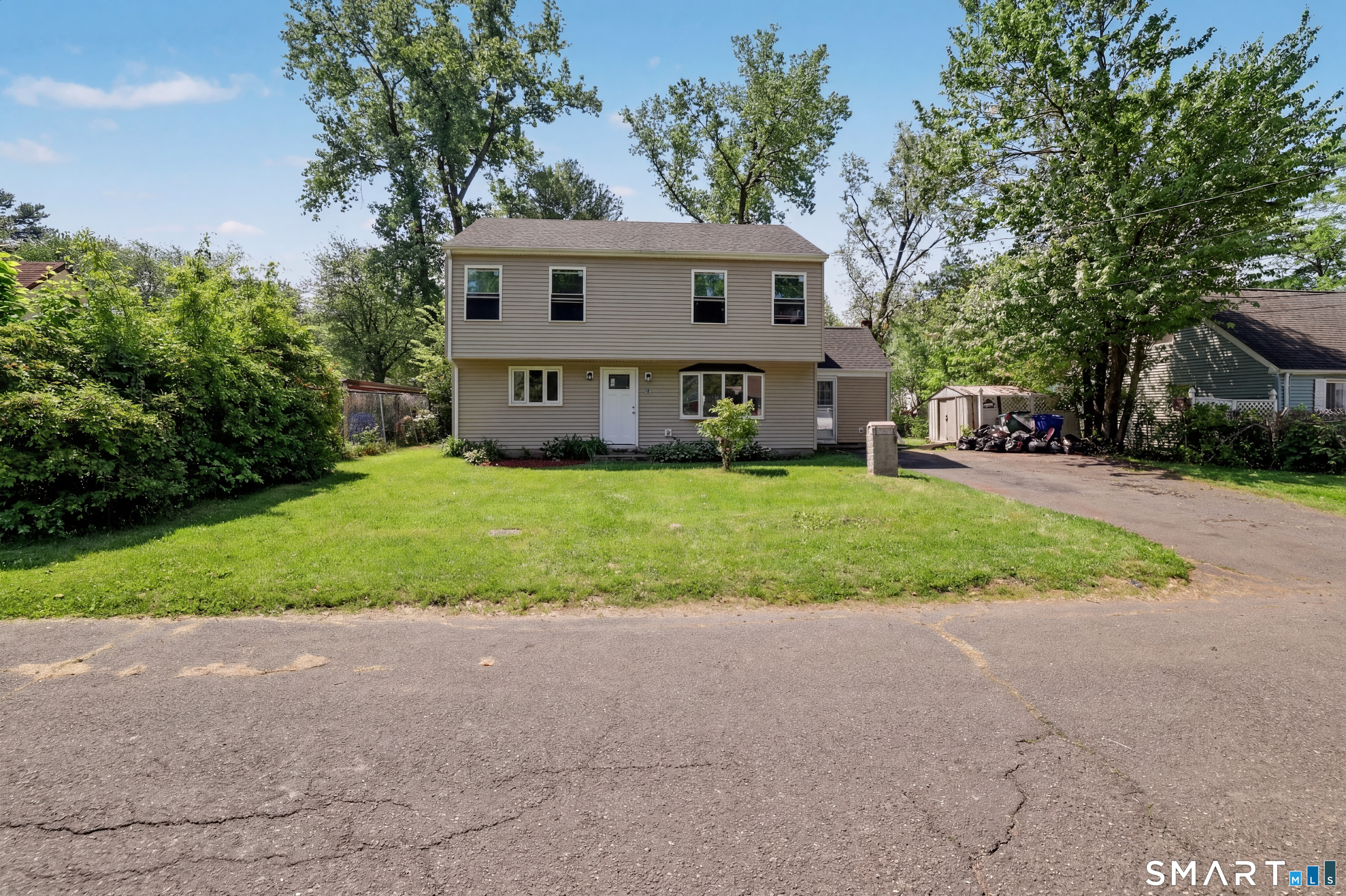 97 Boothbay Street Bloomfield, CT 06002 - Photo 2 of 33 a view of a house with a yard and large tree