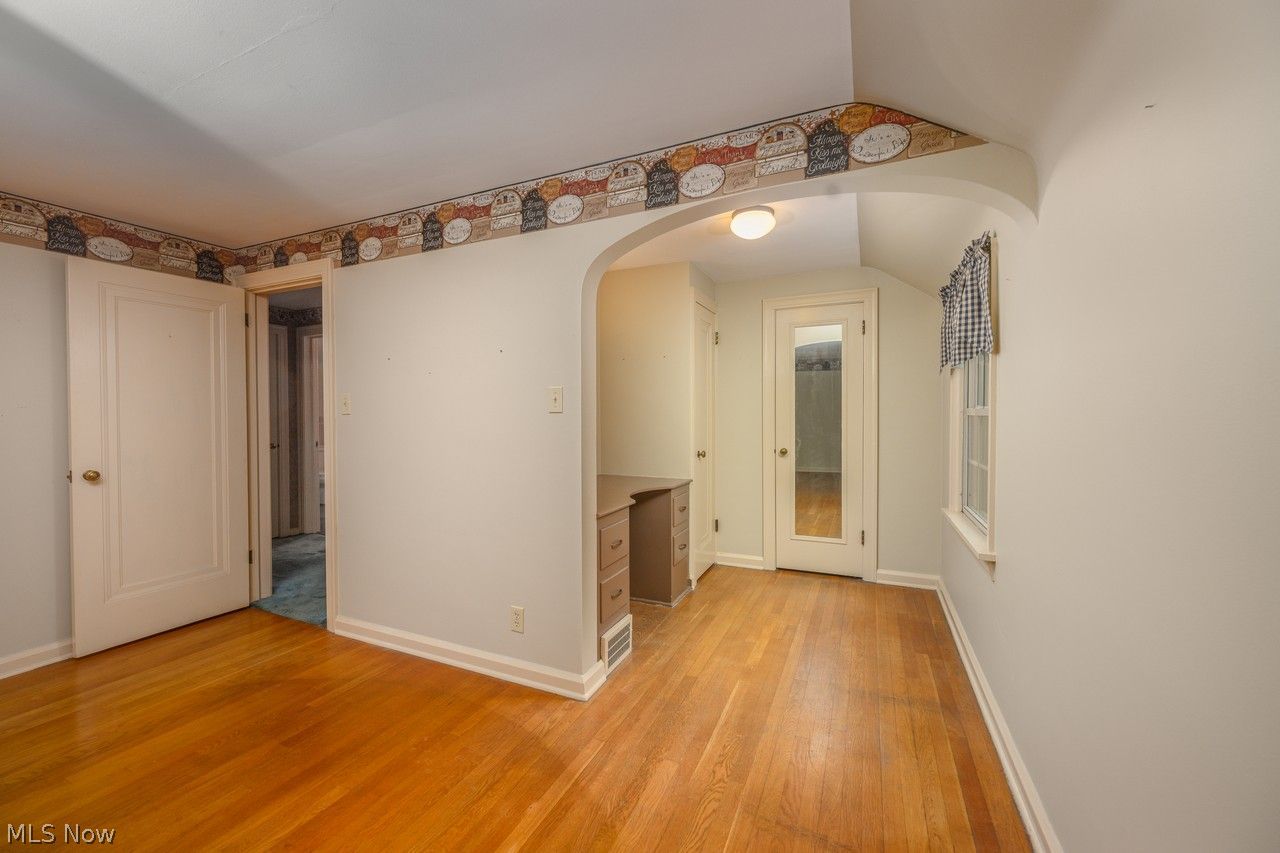 1422 Monument Road Northwest Canton, OH 44703 - Photo 13 of 31 Primary bedroom with multiple windows, ceiling fan and hardwood floors