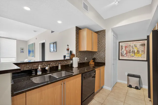 a kitchen with granite countertop a sink and a stove top oven