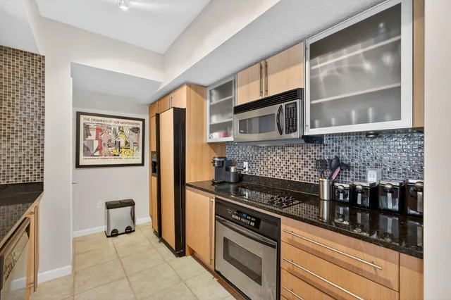 a kitchen with stainless steel appliances granite countertop a stove and a microwave