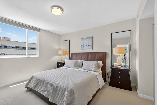 a bedroom with a bed and a night stand