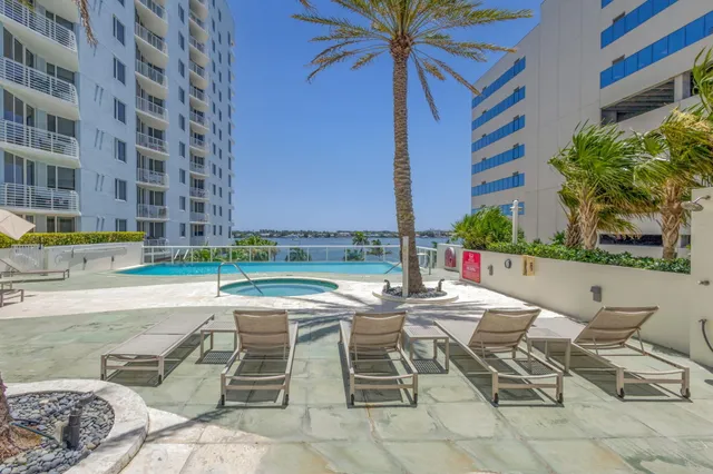 a swimming pool with a yard and outdoor seating