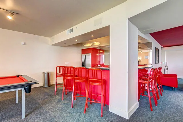 a room with furniture pool table and a window
