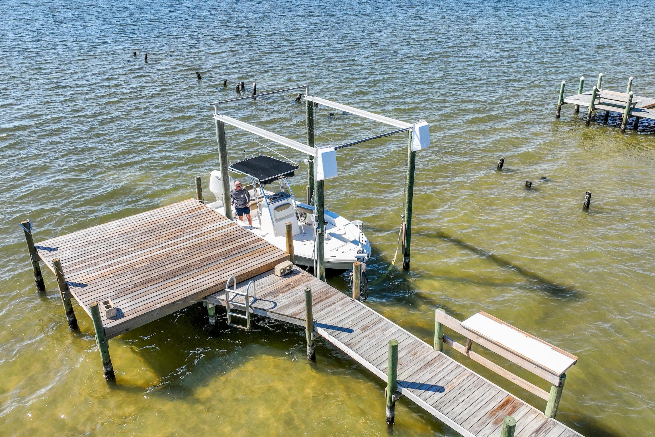 2766 Bay Grove Road Freeport, FL 32439 - Photo 15 of 55 a wooden bench sitting next to a lake