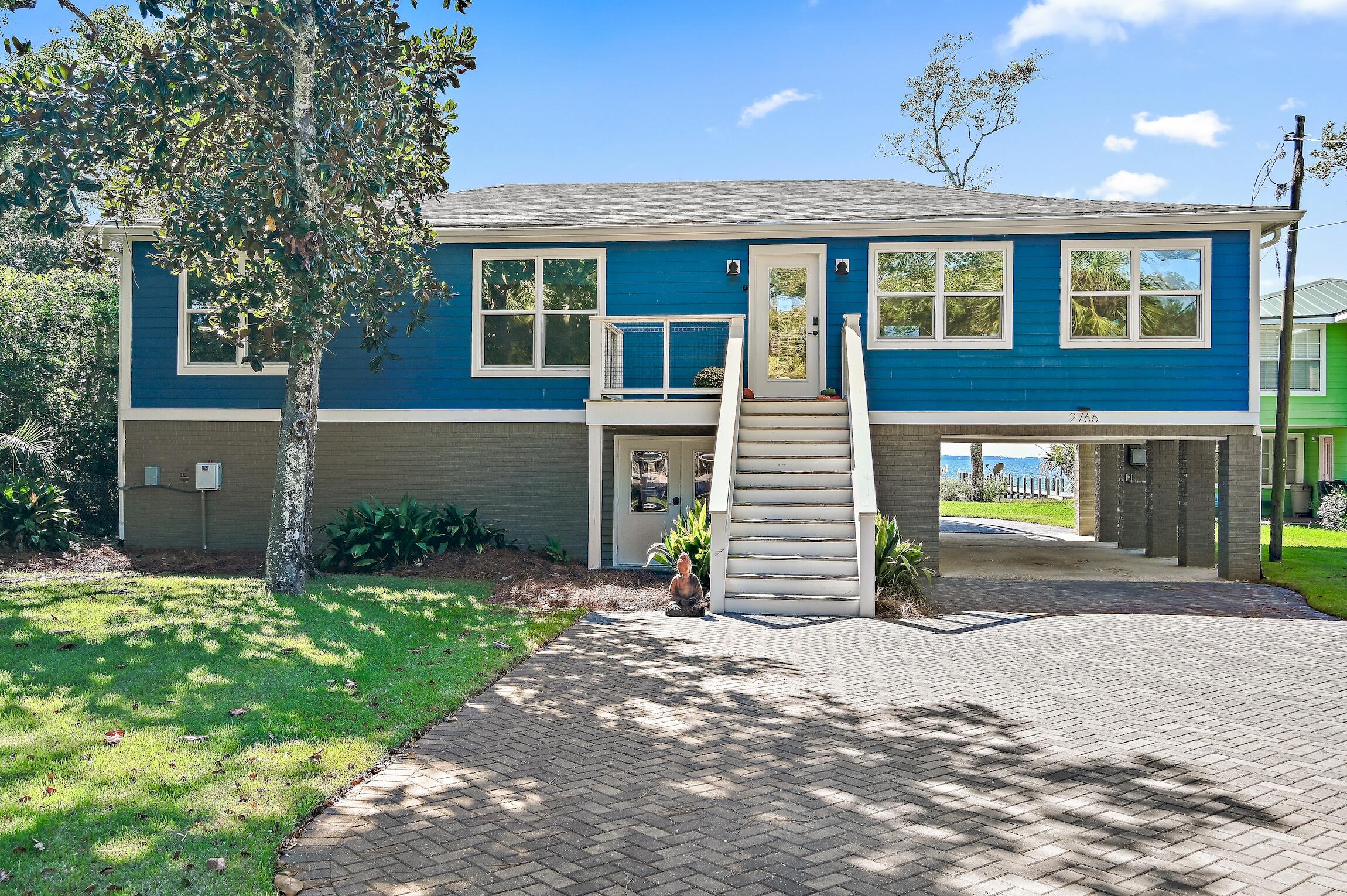 2766 Bay Grove Road Freeport, FL 32439 - Photo 2 of 55 a front view of a house with a yard and garage