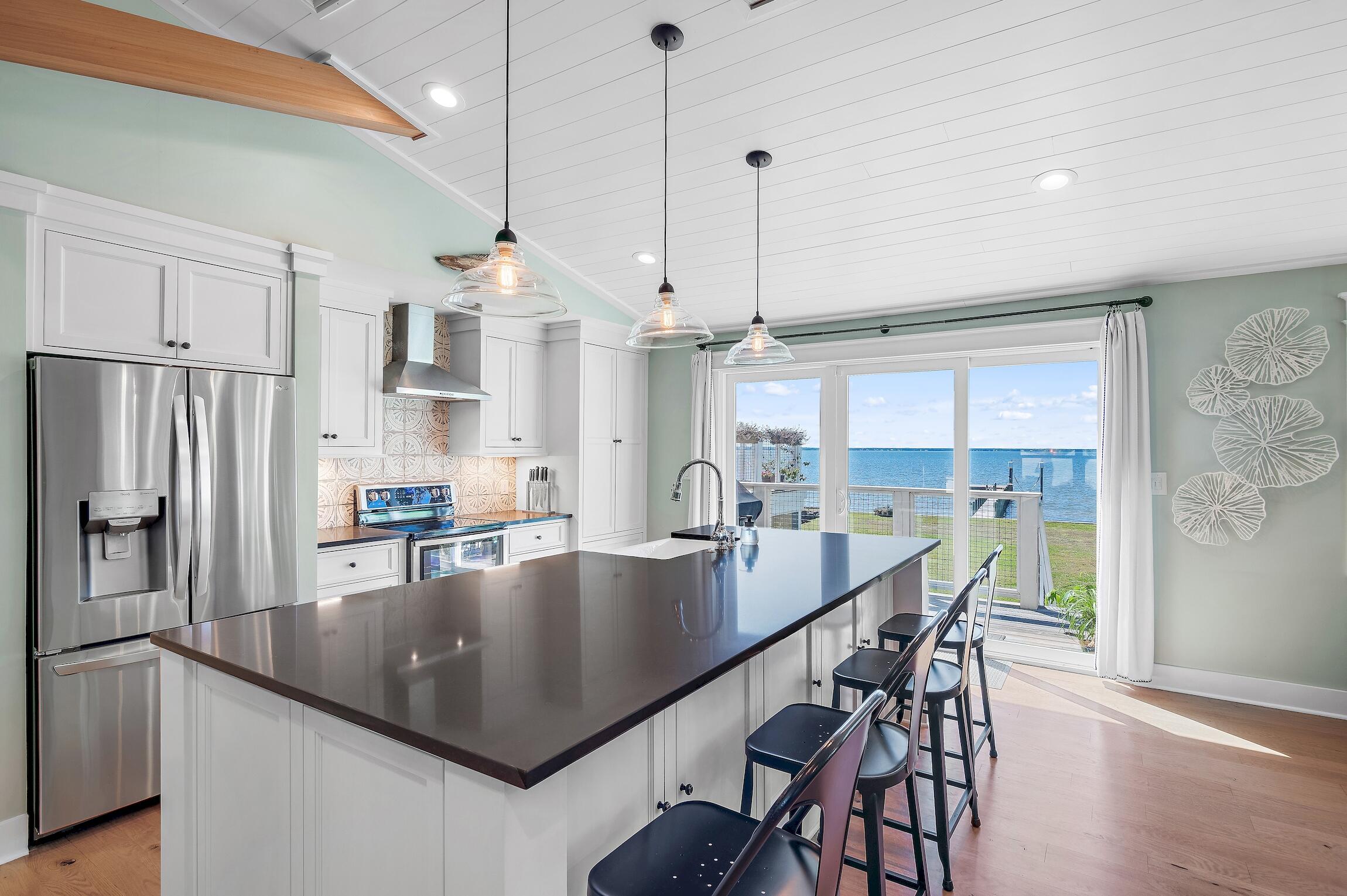 2766 Bay Grove Road Freeport, FL 32439 - Photo 23 of 55 a kitchen with stainless steel appliances granite countertop a sink a stove and chairs