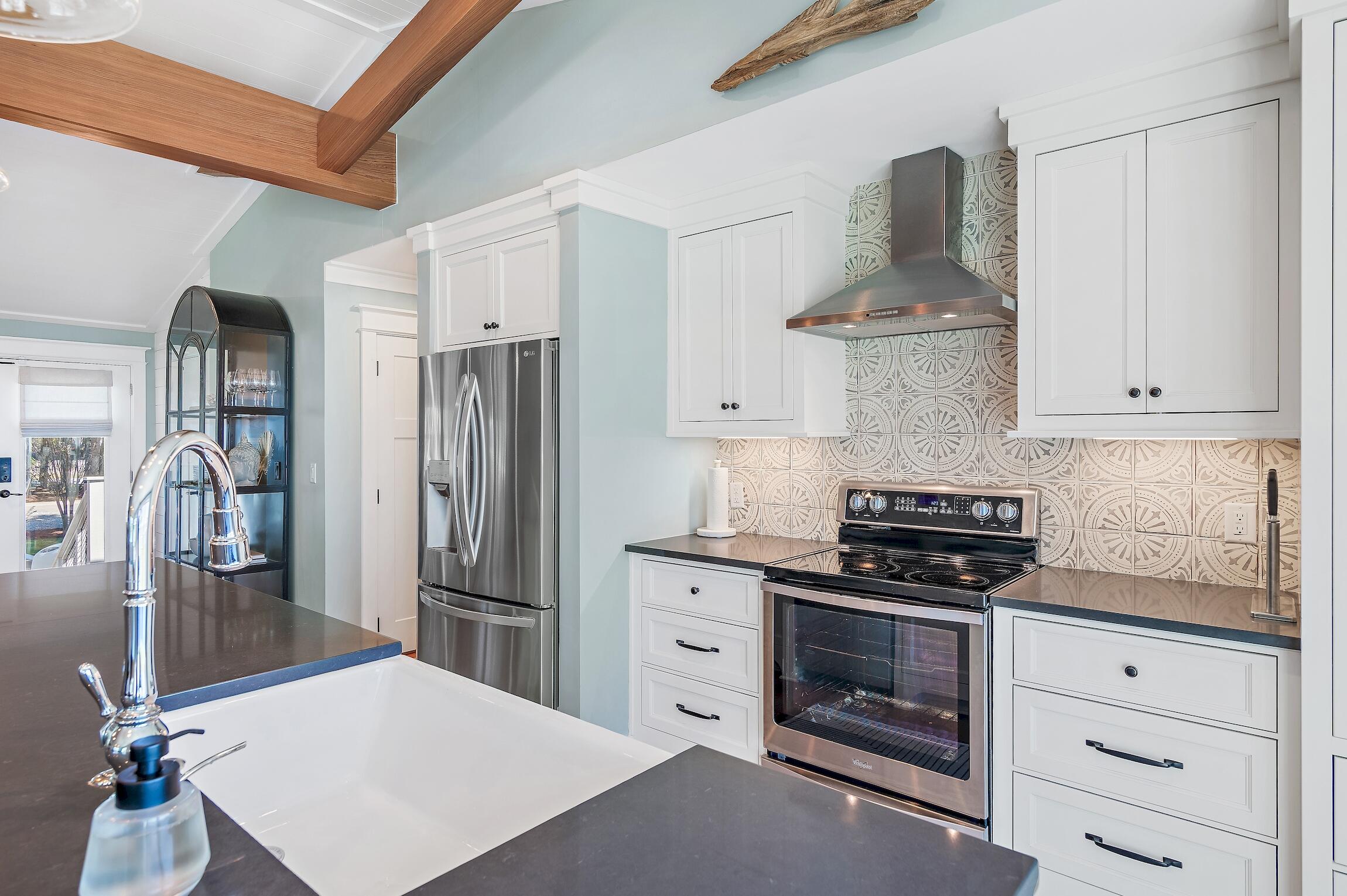 2766 Bay Grove Road Freeport, FL 32439 - Photo 27 of 55 a kitchen with stainless steel appliances a stove refrigerator and cabinets