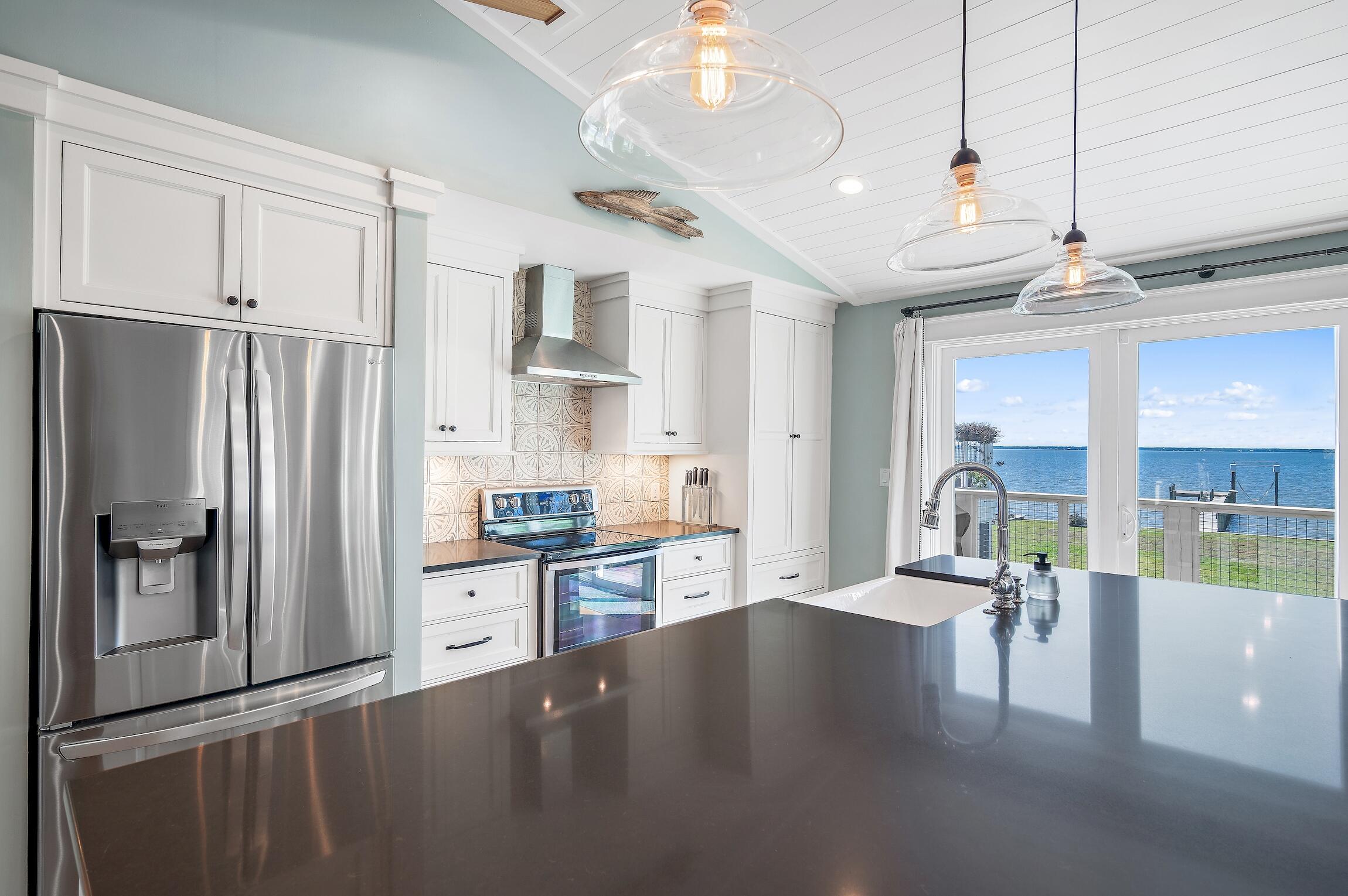 2766 Bay Grove Road Freeport, FL 32439 - Photo 28 of 55 a open kitchen with stainless steel appliances granite countertop a refrigerator a stove and a wooden floors