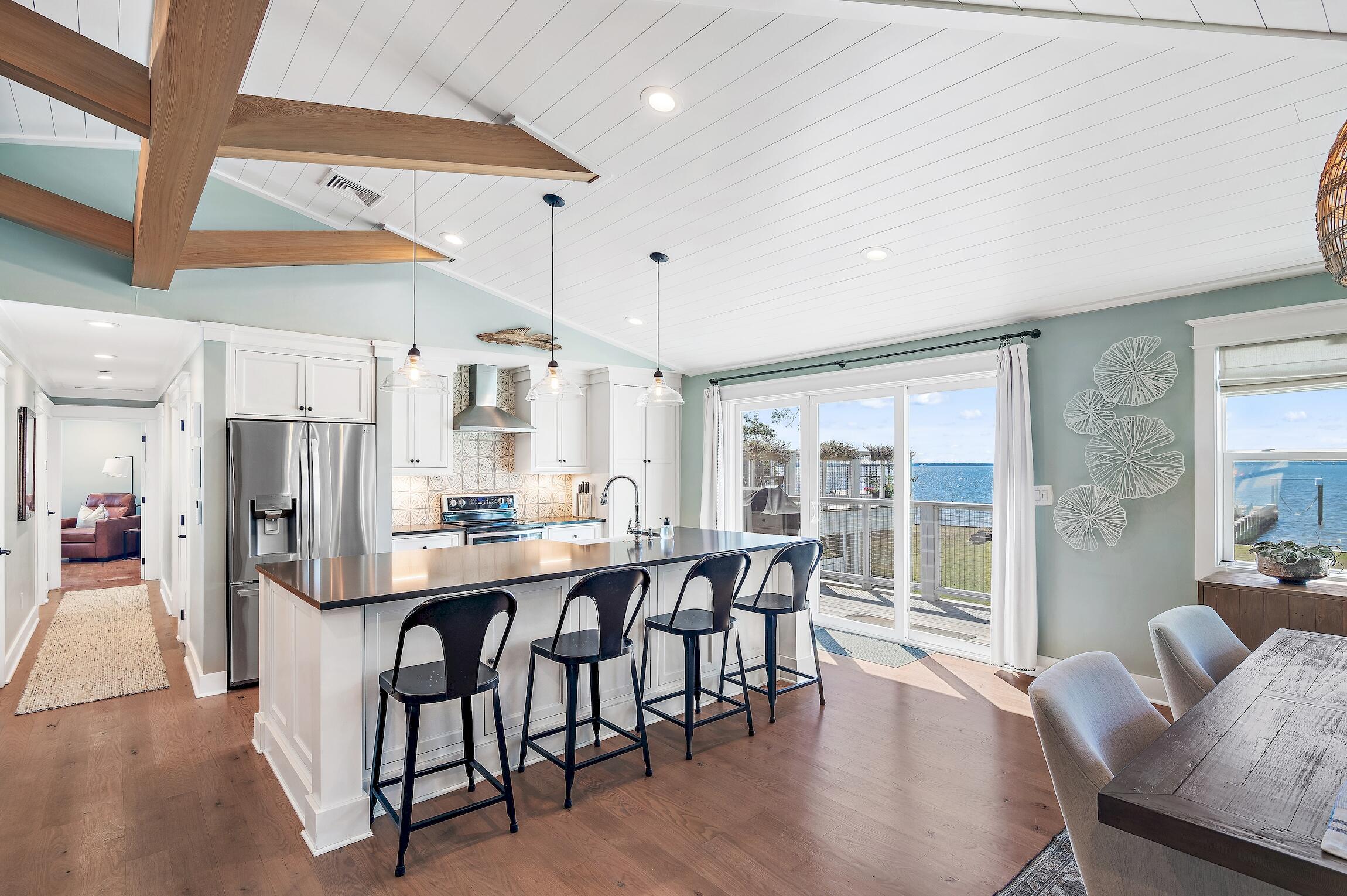 2766 Bay Grove Road Freeport, FL 32439 - Photo 29 of 55 a kitchen with stainless steel appliances kitchen island granite countertop a table chairs sink and cabinets