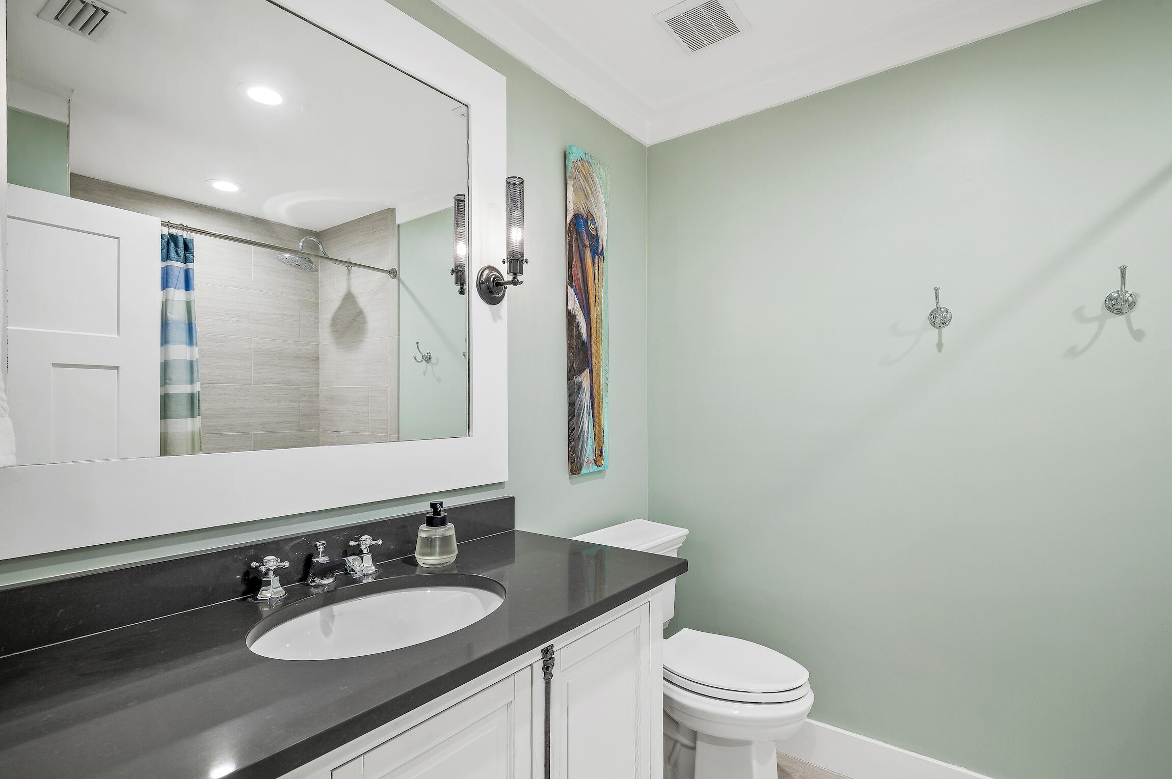 2766 Bay Grove Road Freeport, FL 32439 - Photo 37 of 55 a bathroom with a sink a toilet a mirror a vanity and shower