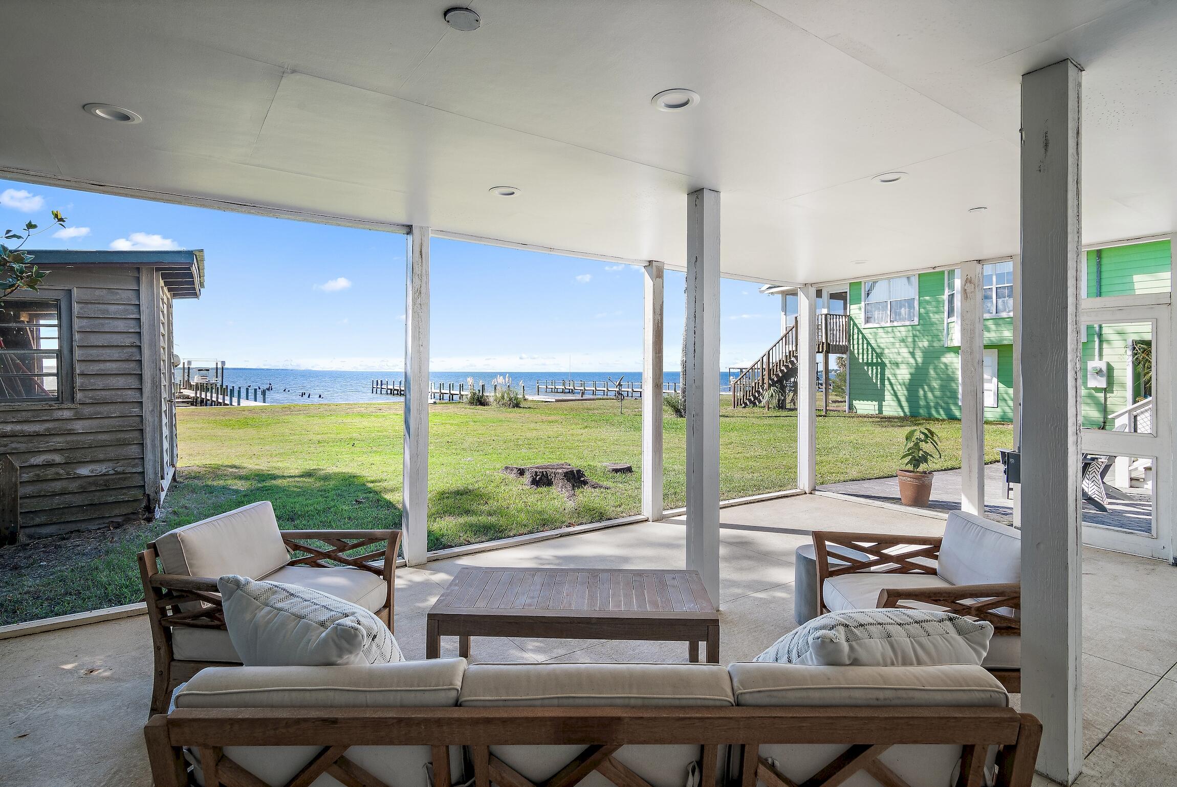 2766 Bay Grove Road Freeport, FL 32439 - Photo 45 of 55 a living room with furniture and floor to ceiling windows