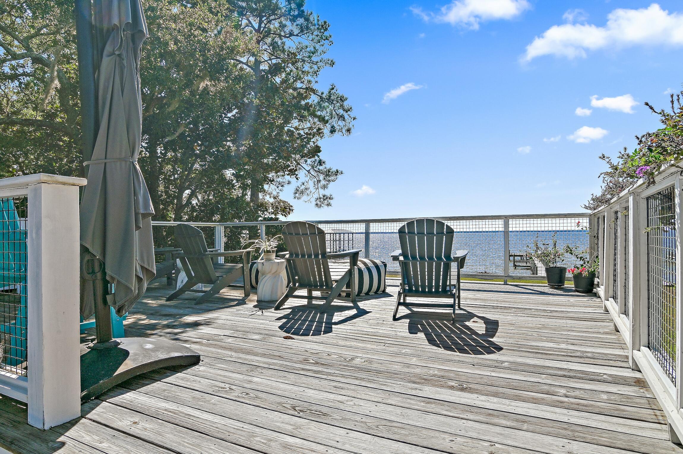 2766 Bay Grove Road Freeport, FL 32439 - Photo 48 of 55 a view of a deck with wooden floor and roof with potted plants and floor to ceiling window