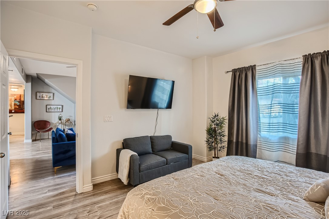 7701 West Robindale Road, Unit 149 Las Vegas, NV 89113 - Photo 12 of 22 Bedroom with light wood-style floors and a ceiling fan