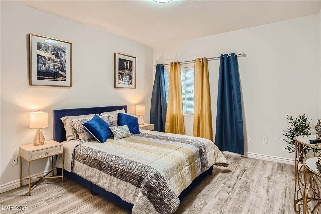 7701 West Robindale Road, Unit 149 Las Vegas, NV 89113 - Photo 15 of 22 Bedroom with light wood-type flooring and baseboards