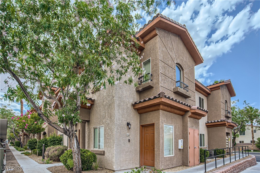 7701 West Robindale Road, Unit 149 Las Vegas, NV 89113 - Photo 2 of 22 View of front of home featuring stucco siding and a tiled roof