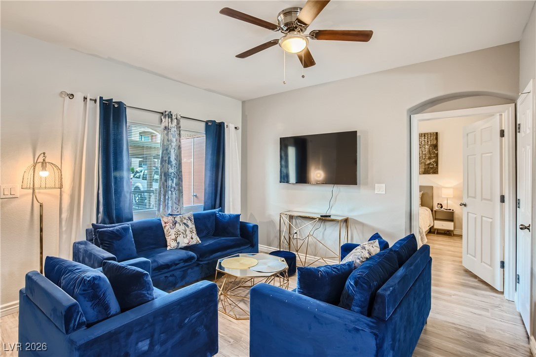 7701 West Robindale Road, Unit 149 Las Vegas, NV 89113 - Photo 4 of 22 Living area with light wood-style floors and ceiling fan