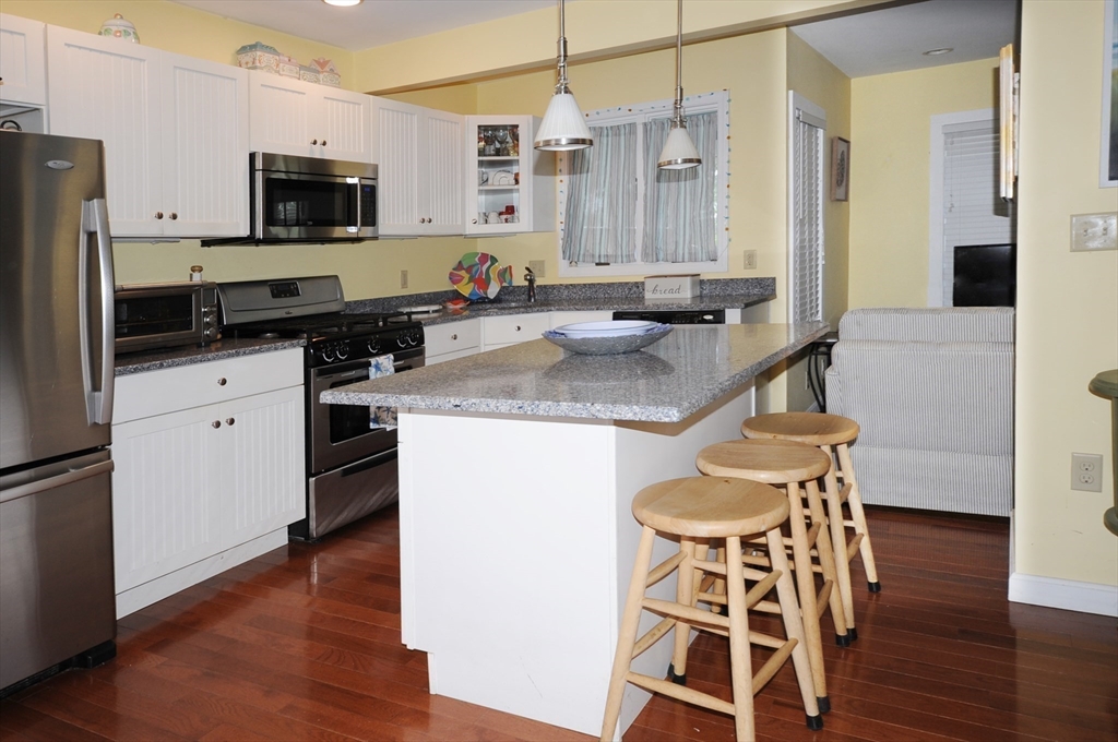 9 15th Street Wareham, MA 02558 - Photo 8 of 27 a kitchen with stainless steel appliances kitchen island granite countertop a stove a sink and a refrigerator