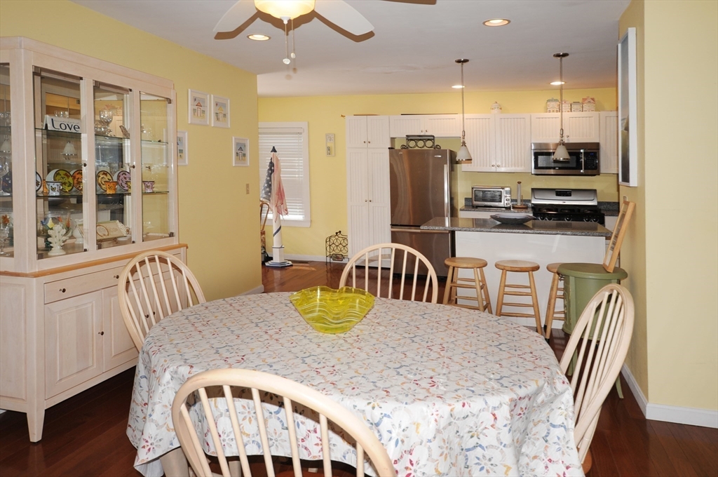9 15th Street Wareham, MA 02558 - Photo 9 of 27 a kitchen with stainless steel appliances kitchen island granite countertop a dining table chairs and a refrigerator